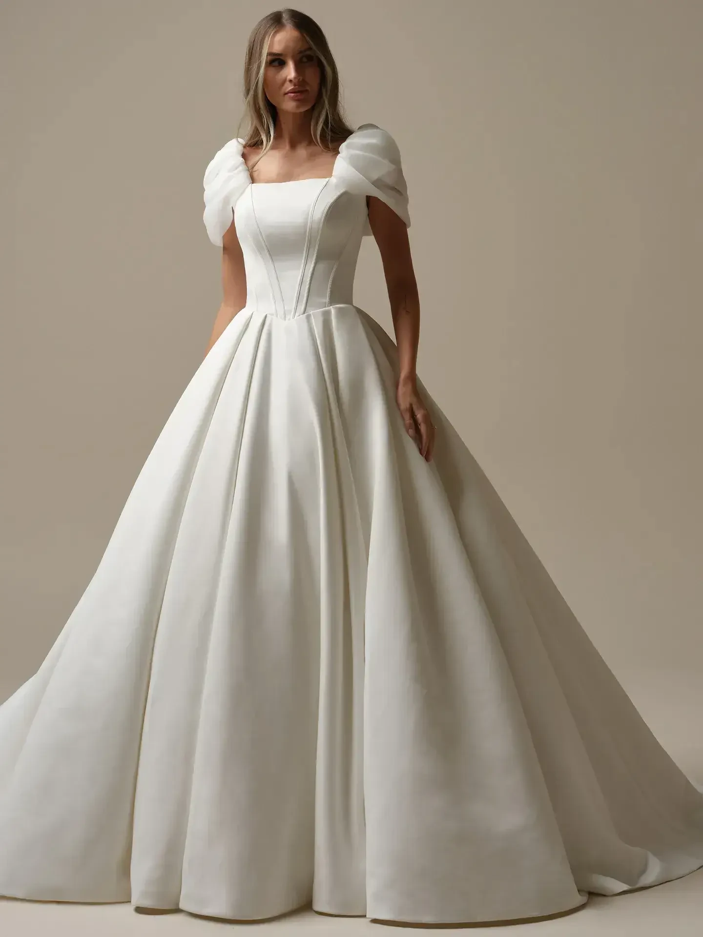model is wearing a short sleeve ball gown wedding dress