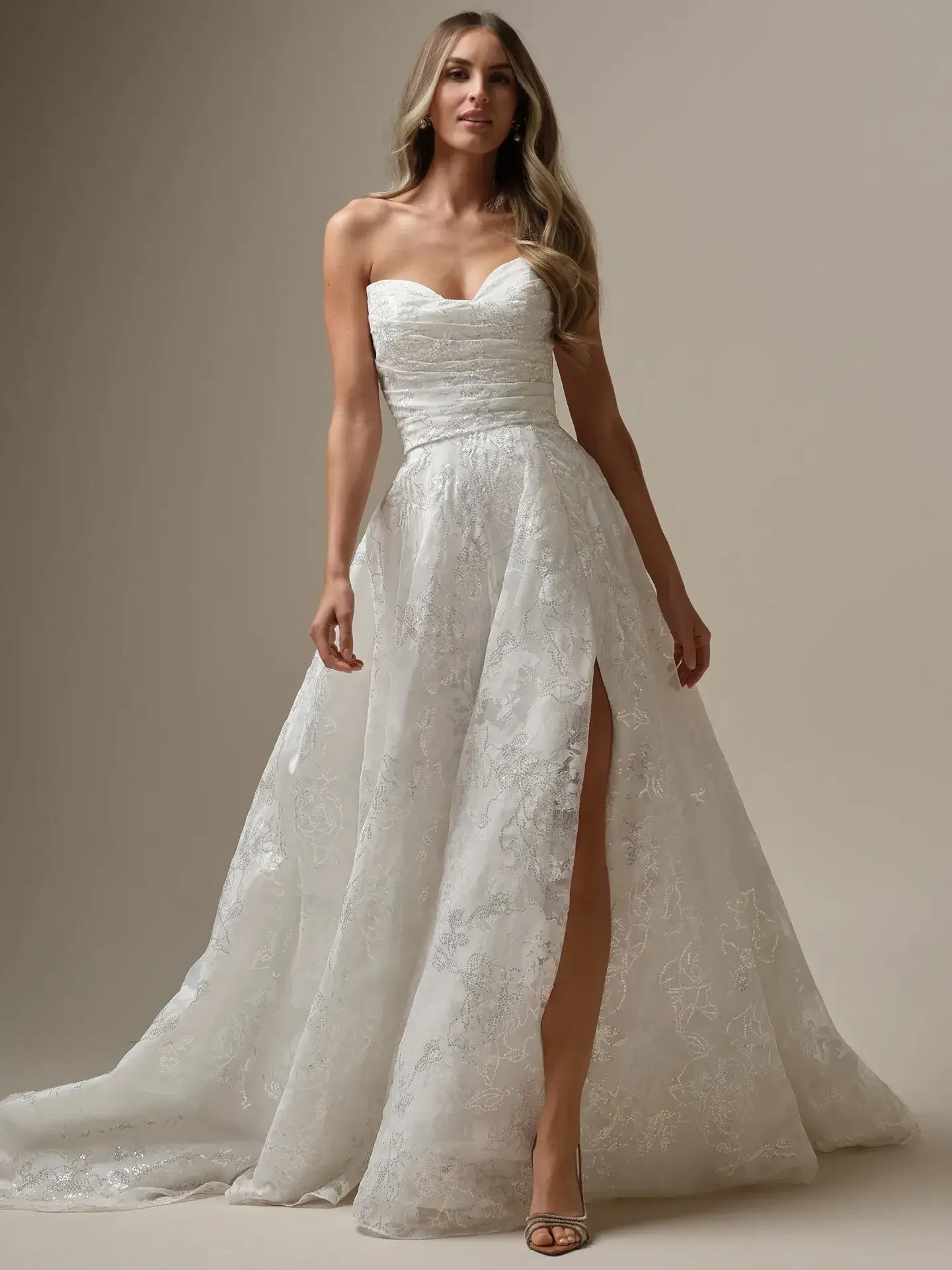 model is wearing an a-line strapless organza wedding dress