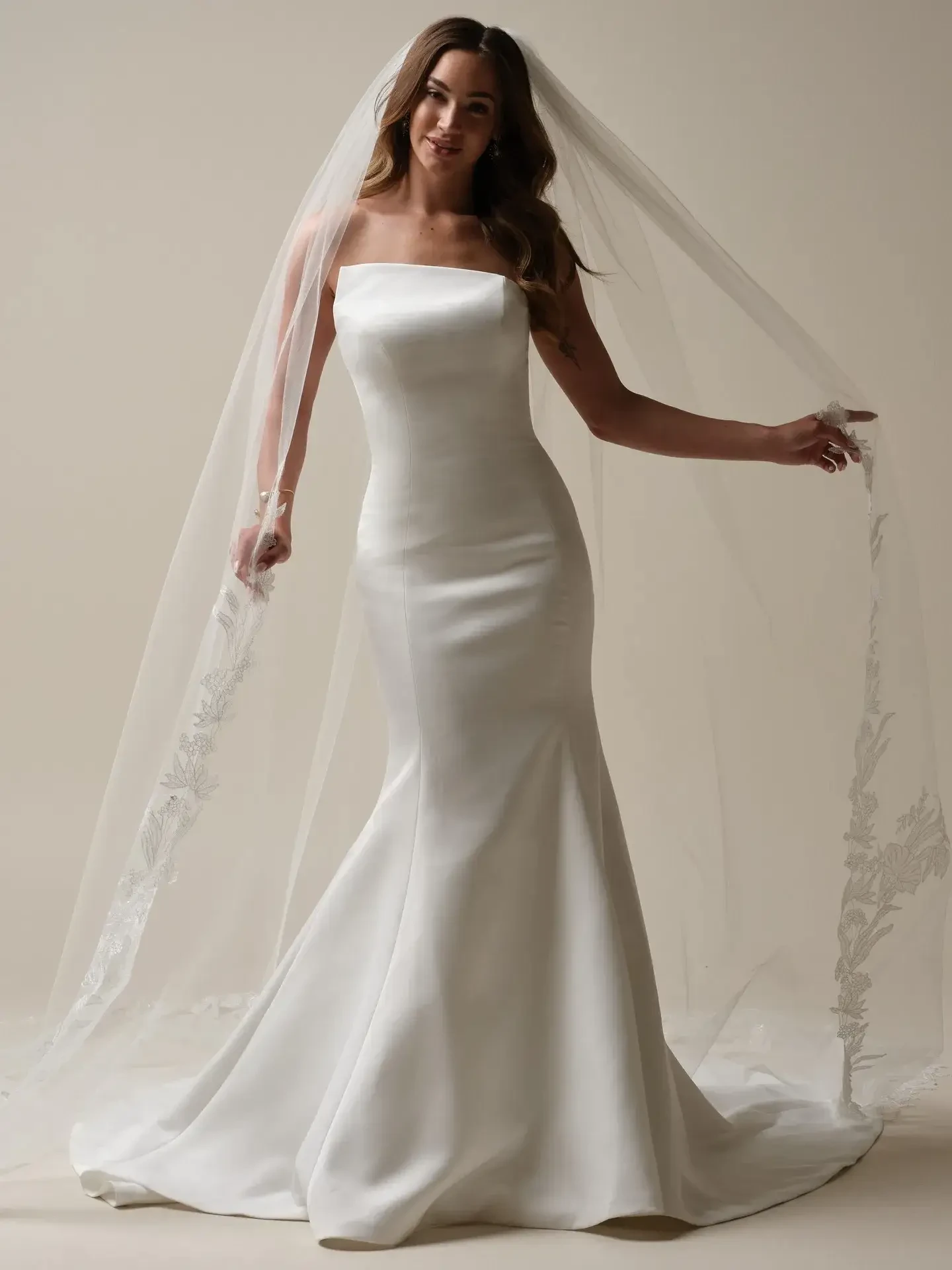 model is wearing a strapless satin wedding dress