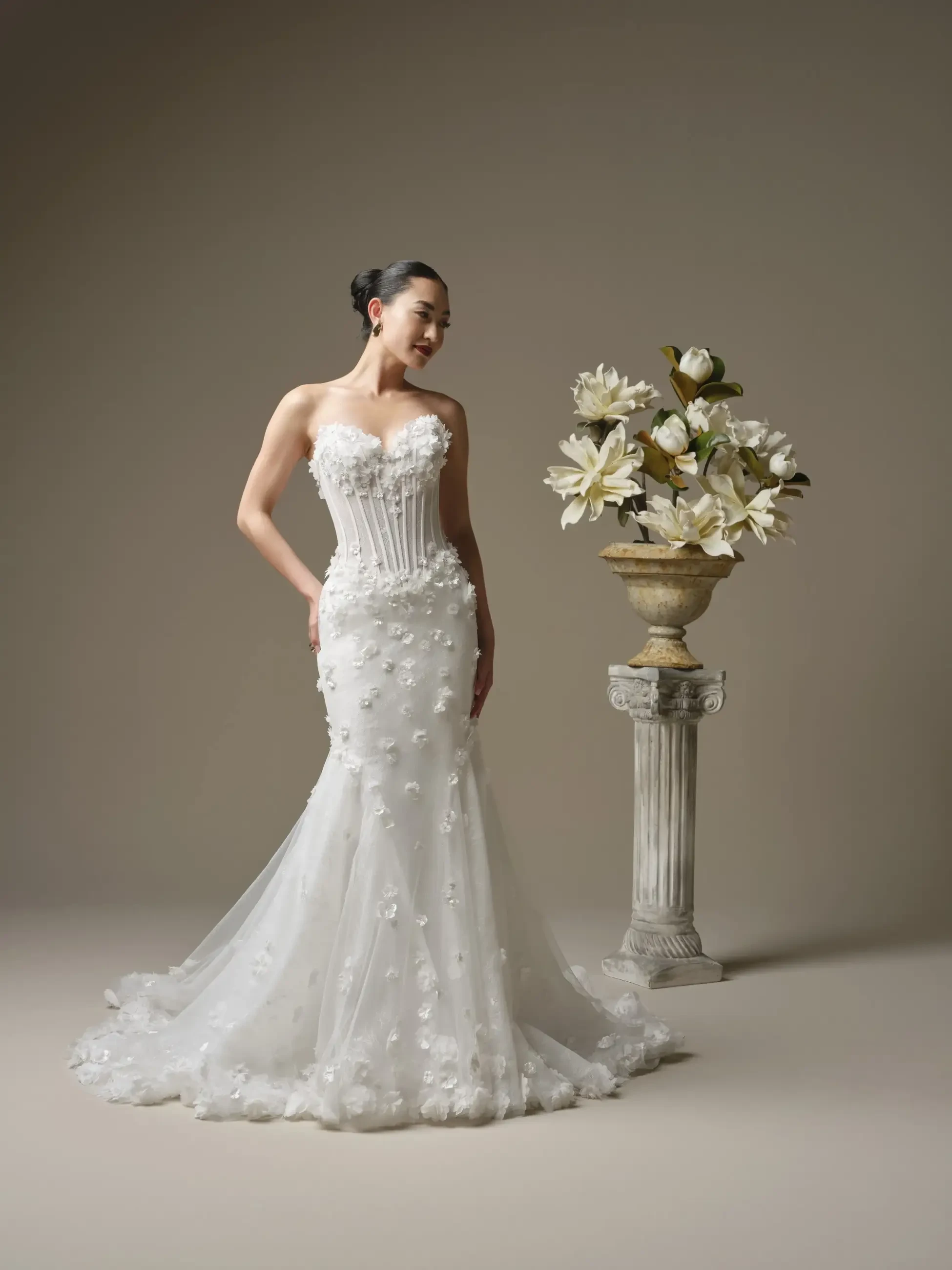 model is wearing a sleeveless lace wedding gown