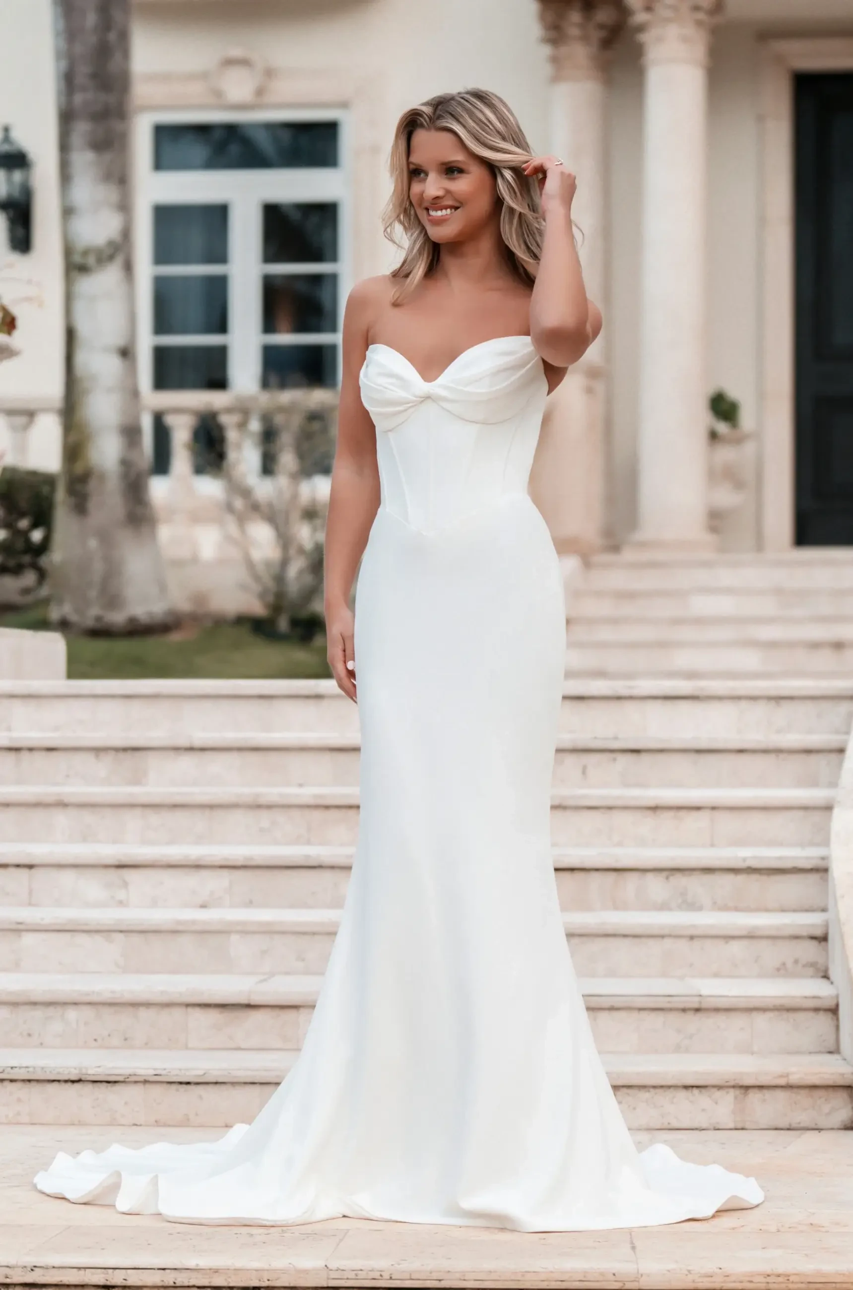model is wearing a strapless crepe wedding dress