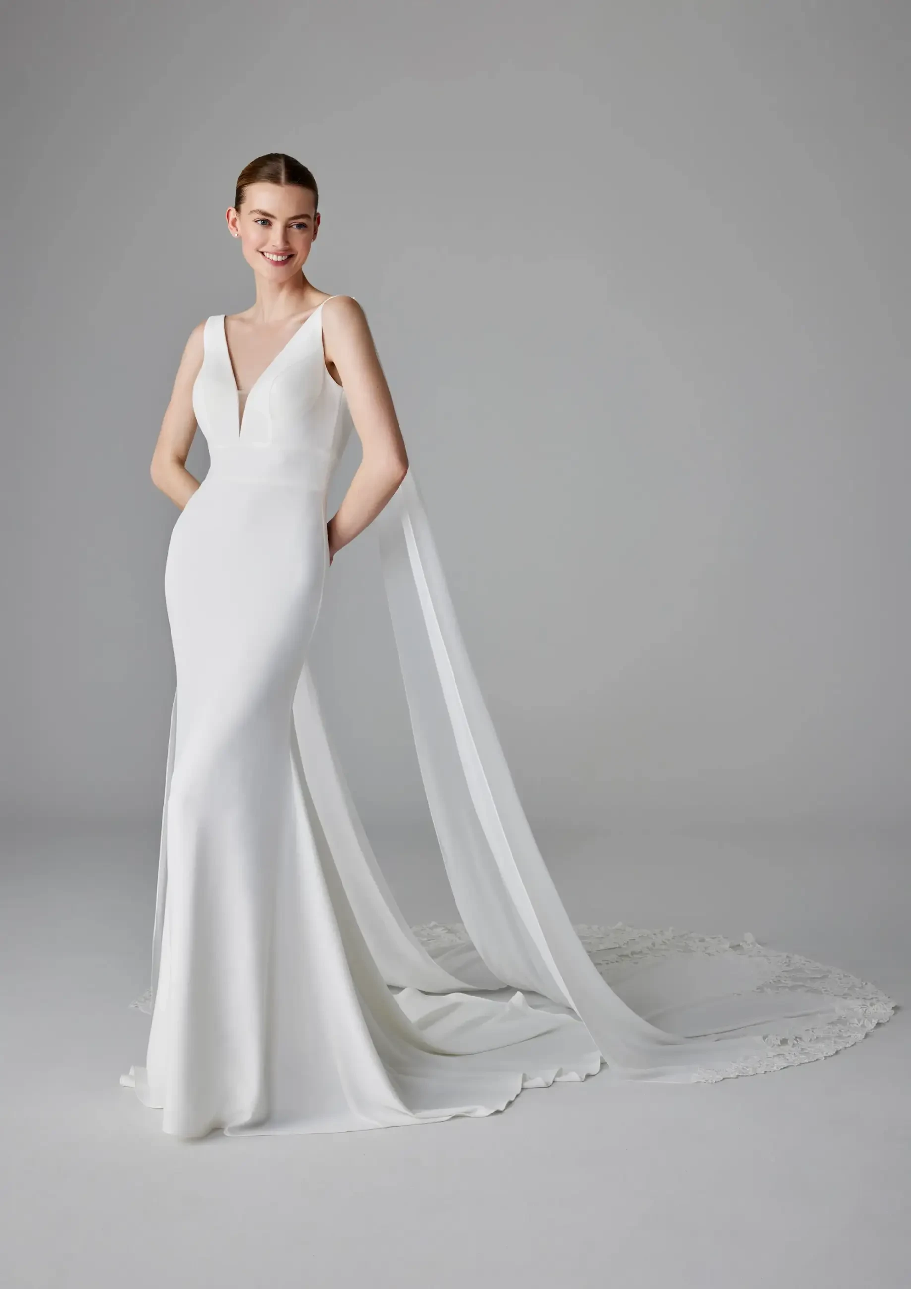 model is wearing a sleeveless v-neckline minimalist wedding gown